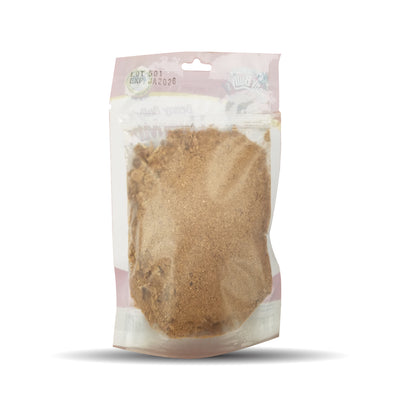 Dog food topper pouch filled with crumbs and powder of beef liver