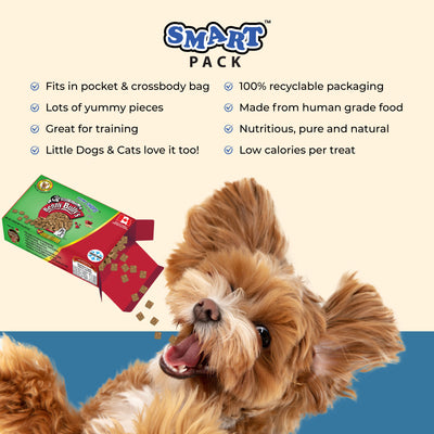 happy dog eating small treats from a green and red box